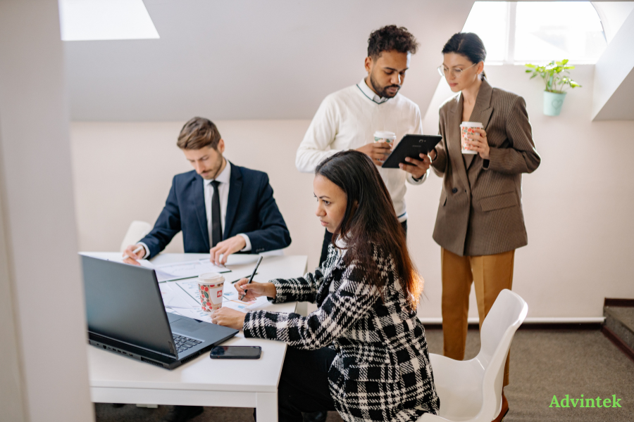 business team reviewing e-invoicing software and compliance documents in an office