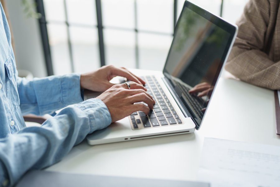 accredited service provider using laptop for invoicing